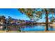 Scenic lake view with a park bench, mountain backdrop and waterfront homes in the neighborhood at 2632 Starfish Ct, Las Vegas, NV 89128