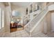 Open-concept living room with a fireplace, staircase and hardwood floors at 2632 Starfish Ct, Las Vegas, NV 89128