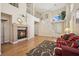 Bright living room featuring hardwood floors, a fireplace and tall windows at 2632 Starfish Ct, Las Vegas, NV 89128