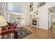 Spacious living room featuring a fireplace, hardwood floors and abundant natural light at 2632 Starfish Ct, Las Vegas, NV 89128