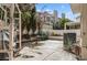Private patio area with lush landscaping, a dining table, and a grill, ideal for outdoor relaxation at 2632 Starfish Ct, Las Vegas, NV 89128