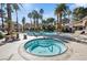 Community pool featuring a hot tub, lounge chairs, tables, and palm trees for a relaxing oasis at 2632 Starfish Ct, Las Vegas, NV 89128