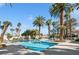 Bright and refreshing pool area with palm trees and lounge chairs providing a relaxing outdoor space at 2632 Starfish Ct, Las Vegas, NV 89128