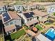 Aerial view shows private backyards, lush lawns, covered patio, pool and solar panels at 27 Parco Fiore Ct, Henderson, NV 89011