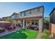 Charming backyard features a covered patio, artificial turf, a fire pit, and outdoor dining at 27 Parco Fiore Ct, Henderson, NV 89011