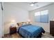 Bright bedroom features a ceiling fan, a large window, and stylish furnishings at 27 Parco Fiore Ct, Henderson, NV 89011