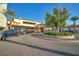 Elegant clubhouse exterior with porte cochere, manicured landscaping, and convenient parking at 27 Parco Fiore Ct, Henderson, NV 89011