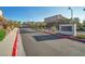 Landscaped entrance to Alta Fiore community with stone signage, well maintained plants and trees and a gated entry at 27 Parco Fiore Ct, Henderson, NV 89011
