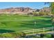 Picturesque golf course view showcasing lush green fairways, distant mountains, and clear blue skies at 27 Parco Fiore Ct, Henderson, NV 89011