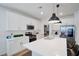 Bright, modern kitchen featuring white cabinetry, stainless steel appliances, and a spacious island at 27 Parco Fiore Ct, Henderson, NV 89011