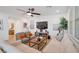 Cozy living room featuring contemporary furnishings, neutral tones, and ample natural light at 27 Parco Fiore Ct, Henderson, NV 89011