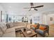 Open-concept living room with contemporary furnishings, seamless flow to kitchen and dining at 27 Parco Fiore Ct, Henderson, NV 89011