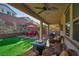 Inviting covered patio with outdoor seating area, a fire pit, and a BBQ grill at 27 Parco Fiore Ct, Henderson, NV 89011