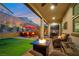 Beautiful backyard with covered patio, a fire pit, BBQ grill and outdoor seating area at 27 Parco Fiore Ct, Henderson, NV 89011