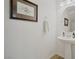 Clean, simple powder room with modern fixtures, neutral tones, and a decorative mirror at 27 Parco Fiore Ct, Henderson, NV 89011