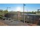 Well-maintained tennis courts surrounded by fencing, lighting, and mature trees for an active lifestyle at 27 Parco Fiore Ct, Henderson, NV 89011