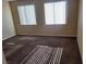 Bedroom featuring neutral walls and carpet, illuminated by natural light from two windows at 2748 Brinkley Manor St, Laughlin, NV 89029