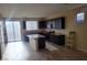 Modern kitchen featuring stainless steel appliances, dark cabinets, and a large island for cooking at 2748 Brinkley Manor St, Laughlin, NV 89029