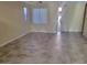 Bright living area with tile flooring, white trim, and contemporary ceiling fan with views of the entry door at 2748 Brinkley Manor St, Laughlin, NV 89029