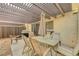 A covered patio provides shade over an outdoor dining area with barbecue grill and fencing at 3261 Ennis Ct, Las Vegas, NV 89121