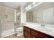 This clean bathroom features a shower stall, bright lighting, and a dark wood vanity at 3261 Ennis Ct, Las Vegas, NV 89121
