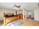 This spacious primary bedroom features a ceiling fan, wood floors, and an ensuite bathroom at 3261 Ennis Ct, Las Vegas, NV 89121