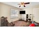 This bedroom features a ceiling fan, closet, window, comfortable seating, and a tv at 3261 Ennis Ct, Las Vegas, NV 89121