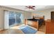 This spacious bedroom features a ceiling fan, wood floors, and a sliding glass door to the patio at 3261 Ennis Ct, Las Vegas, NV 89121