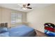 Bright bedroom with ceiling fan, natural light from window, and cozy carpeted floor at 3261 Ennis Ct, Las Vegas, NV 89121