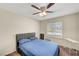 A comfortable bedroom features a ceiling fan, cozy carpet, and bright natural light at 3261 Ennis Ct, Las Vegas, NV 89121