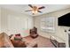 This bedroom features a ceiling fan, closet, window, and a comfortable couch at 3261 Ennis Ct, Las Vegas, NV 89121