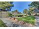 Lush green space within the community featuring mature landscaping and sidewalks at 3261 Ennis Ct, Las Vegas, NV 89121