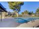 Community pool with clear water, surrounded by fencing and mature trees at 3261 Ennis Ct, Las Vegas, NV 89121