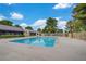 Large community pool with clear water, surrounded by fencing and lush greenery at 3261 Ennis Ct, Las Vegas, NV 89121