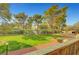 Well-maintained front yard featuring lush grass and mature trees under a clear blue sky at 3261 Ennis Ct, Las Vegas, NV 89121