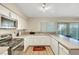 Clean kitchen features white cabinets, stainless steel appliances, and backyard access at 3261 Ennis Ct, Las Vegas, NV 89121