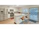 Well-lit kitchen boasts stainless steel appliances, white cabinets, and a breakfast bar at 3261 Ennis Ct, Las Vegas, NV 89121