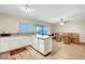 Open kitchen flows into dining area, featuring white cabinets and sleek countertops at 3261 Ennis Ct, Las Vegas, NV 89121