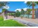 Outdoor seating area next to a tennis court with lush landscaping at 3261 Ennis Ct, Las Vegas, NV 89121