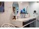 Bathroom featuring double sinks with marble countertops, a stylish mirror, and modern fixtures at 3586 Spencer St, Las Vegas, NV 89169