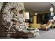 Unique living area featuring a rock waterfall and mid-century modern furniture at 3586 Spencer St, Las Vegas, NV 89169