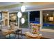 Stylish living area with mid-century modern furniture and views of the pool area through sliding glass doors at 3586 Spencer St, Las Vegas, NV 89169