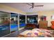 Bright primary bedroom with colorful bed spread, backyard pool view, and en-suite bath at 3586 Spencer St, Las Vegas, NV 89169