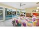 Bright primary bedroom featuring view of the pool, work space, and en-suite bath at 3586 Spencer St, Las Vegas, NV 89169