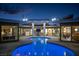 Outdoor courtyard pool illuminated at dusk, surrounded by modern architecture at 3586 Spencer St, Las Vegas, NV 89169