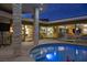 Evening view of the courtyard pool, surrounded by well-lit modern architecture at 3586 Spencer St, Las Vegas, NV 89169