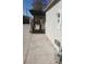 Home's side yard featuring concrete walkway, privacy wall, and access to covered structure at 3711 Southern Light Dr, Las Vegas, NV 89115