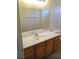 Bathroom vanity with wood cabinets, sink and large mirror at 3883 Winter Whitetail St, Las Vegas, NV 89122