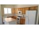 Functional kitchen with classic cabinetry, white appliances, and an island at 3883 Winter Whitetail St, Las Vegas, NV 89122