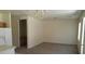 Open-concept living room with neutral carpet, natural light and backyard access at 3883 Winter Whitetail St, Las Vegas, NV 89122